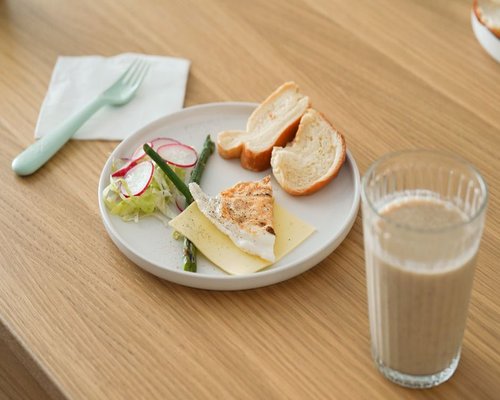 A glass of water and a simple homemade lunch on a wooden table